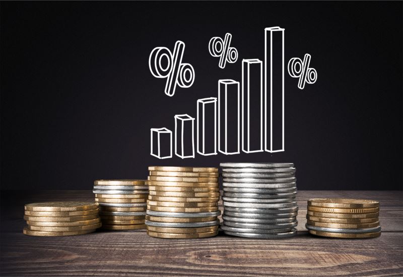 Stacked coins with a percentage graph doodle above