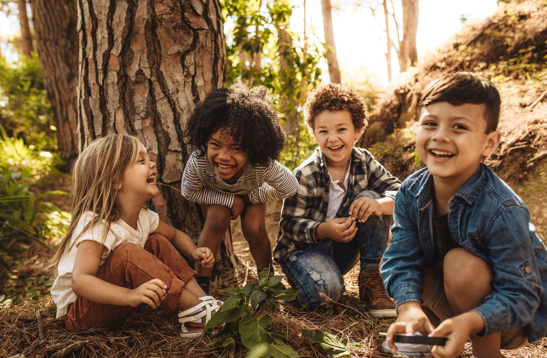 Children sitting in front of a tree